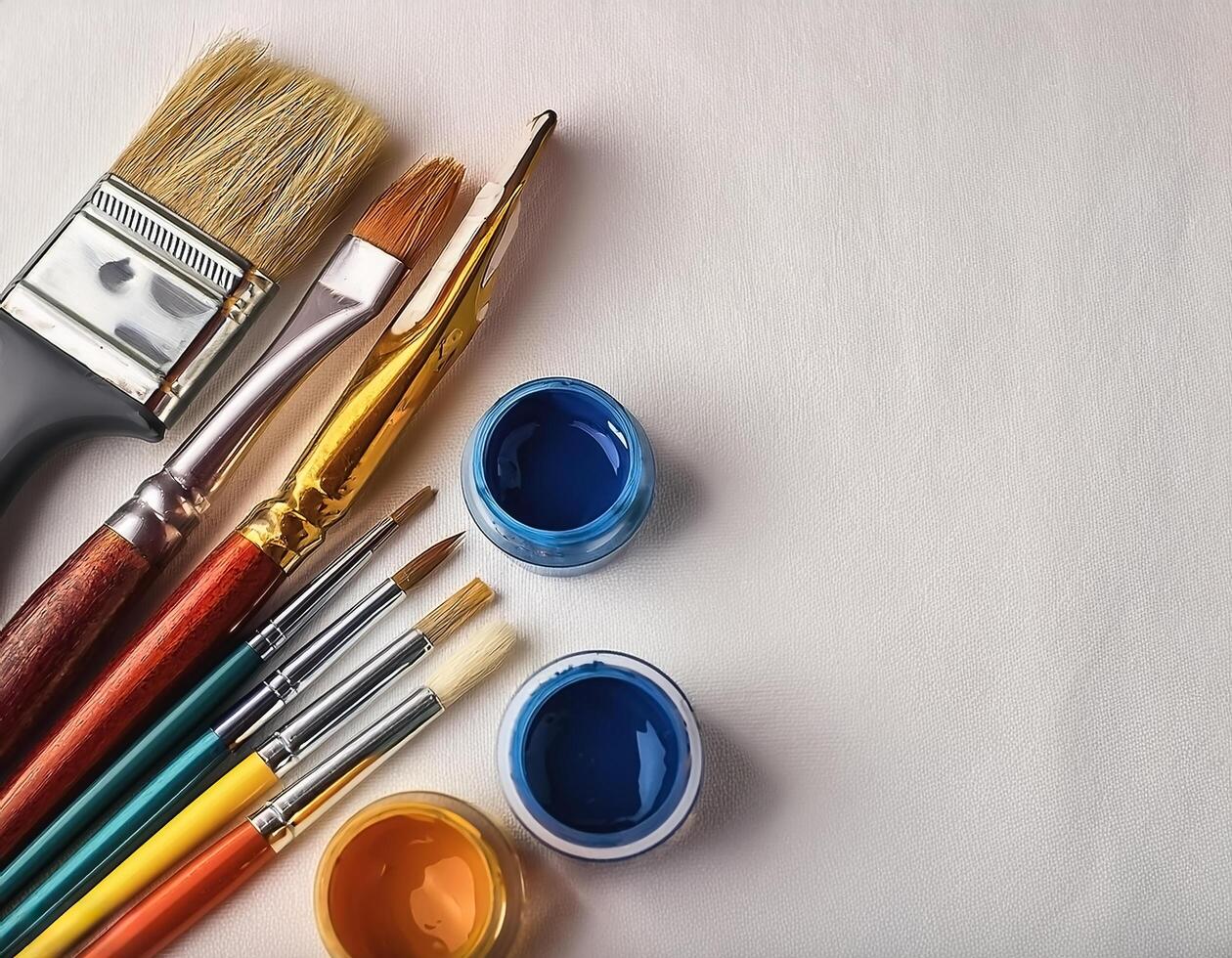 Paint and brushes lie on a white canvas. Creative Activities photo
