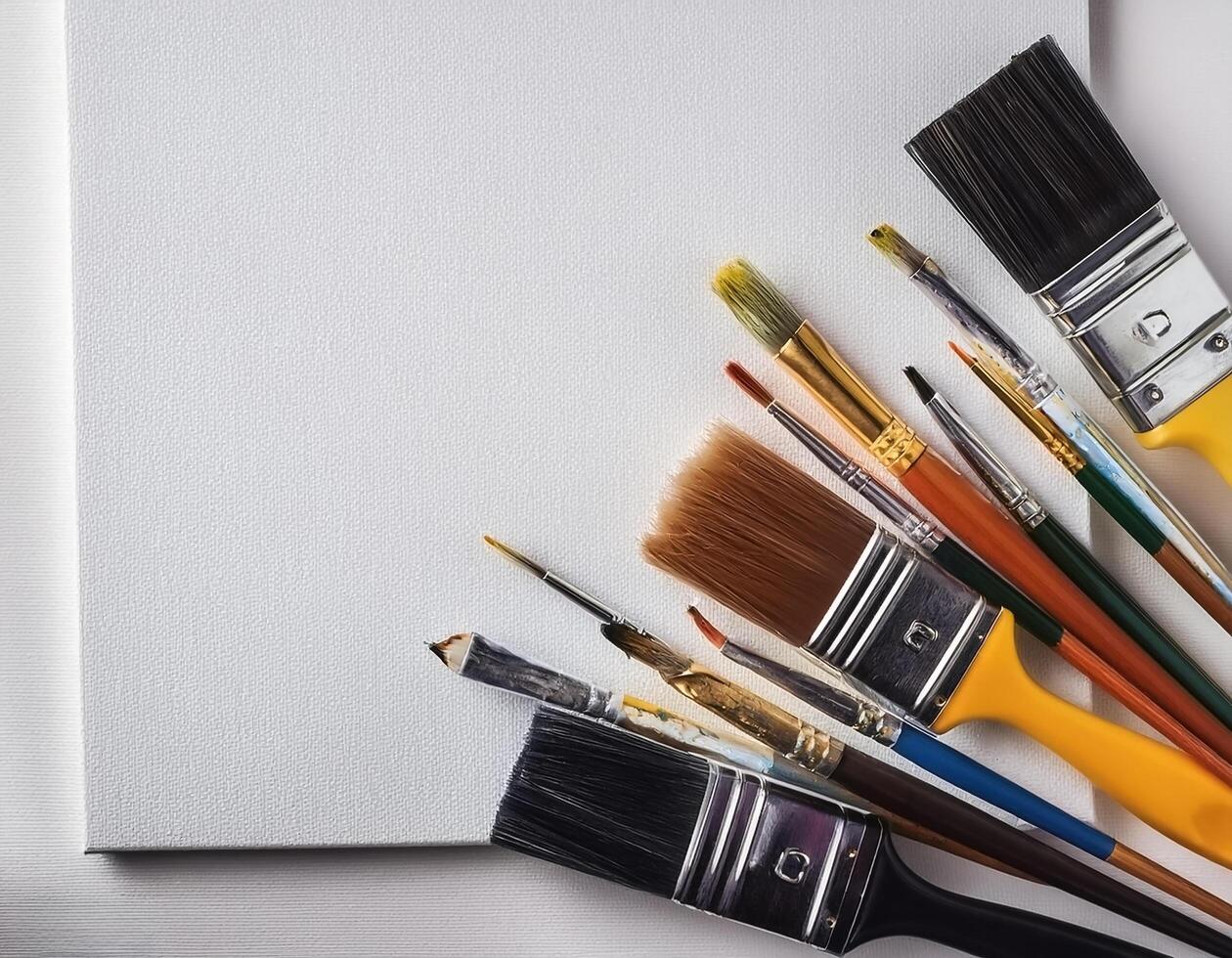 Paint and brushes lie on a white canvas. Creative Activities photo