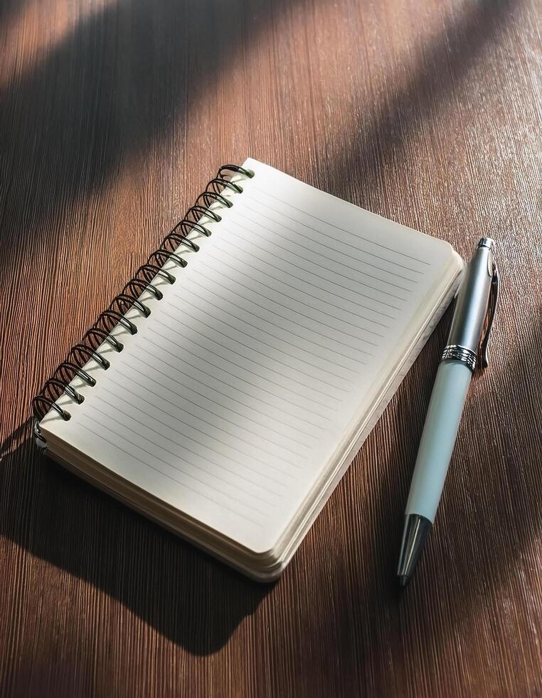 Pen and notebook placed on a clean table photo