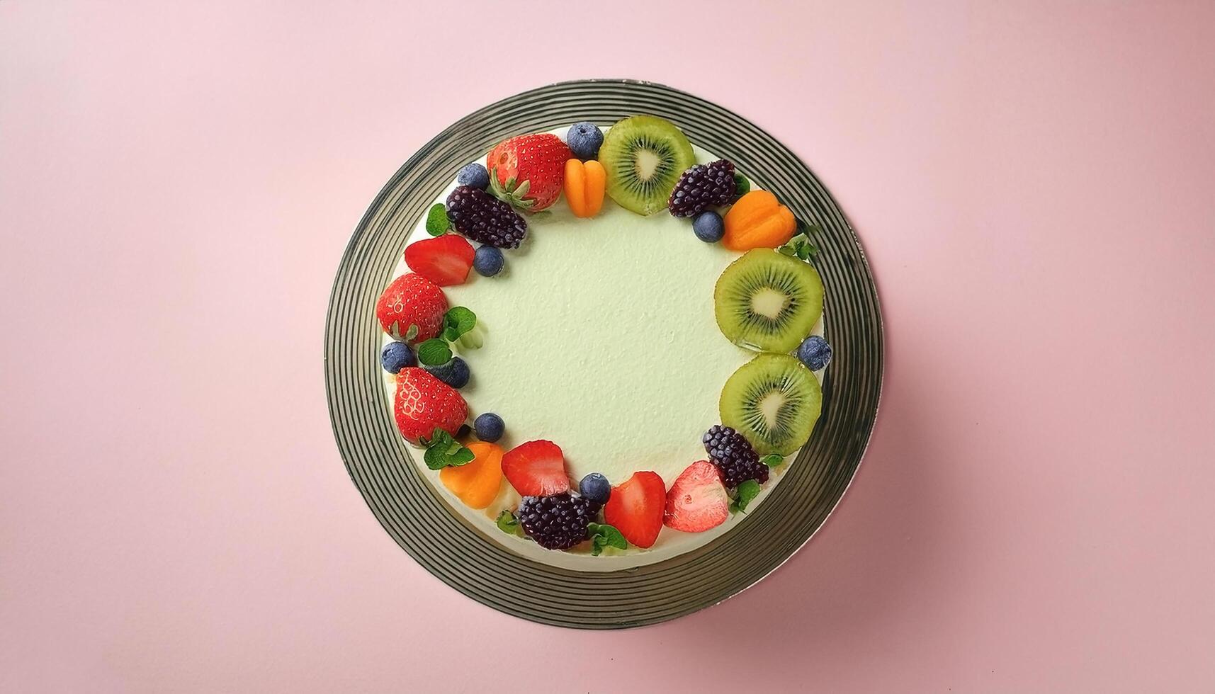 Vegan cake with fresh fruit decoration, on pastel background photo