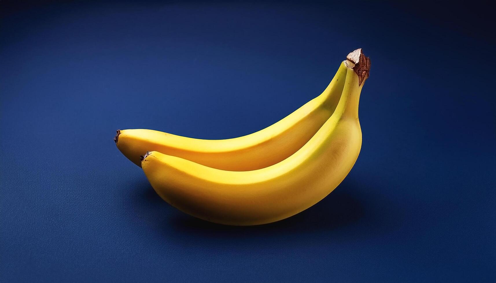 Yellow banana isolated on navy blue background photo