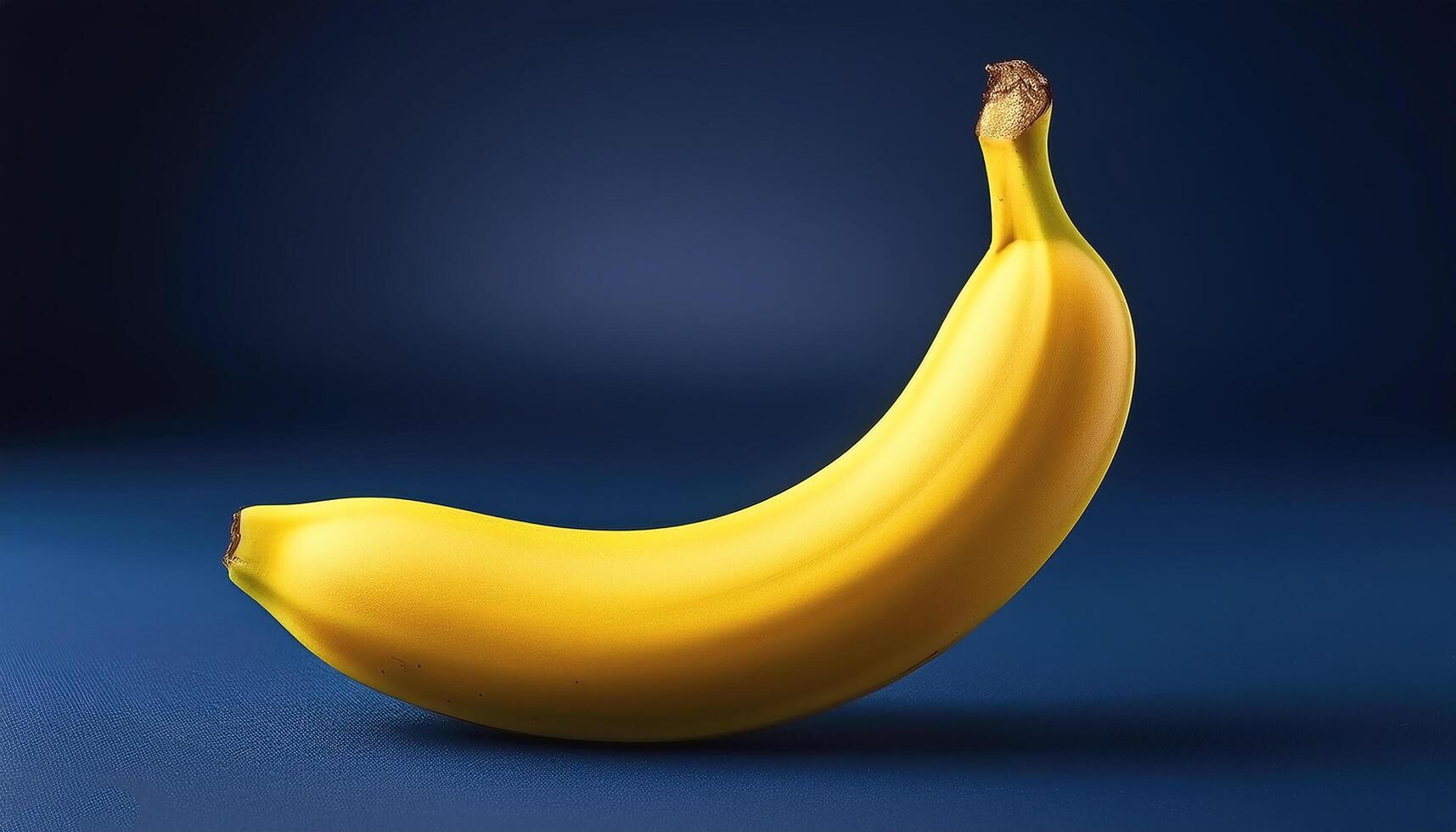 Yellow banana isolated on navy blue background photo