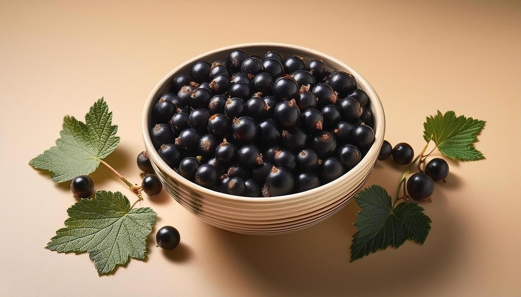Black currants in a bowl, surrounded on a beige background photo