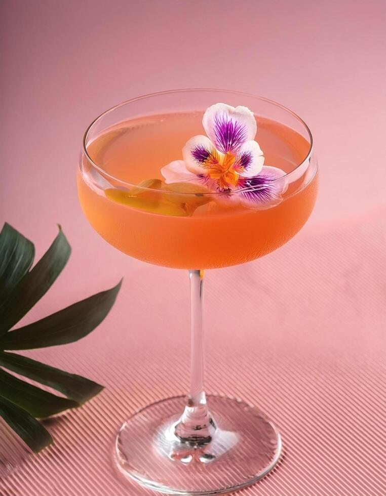 Cocktail with edible flower garnish, on pastel background photo