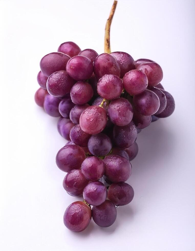 A bunch of purple grapes with one separate grain, focus on the skin texture isolated on white background photo