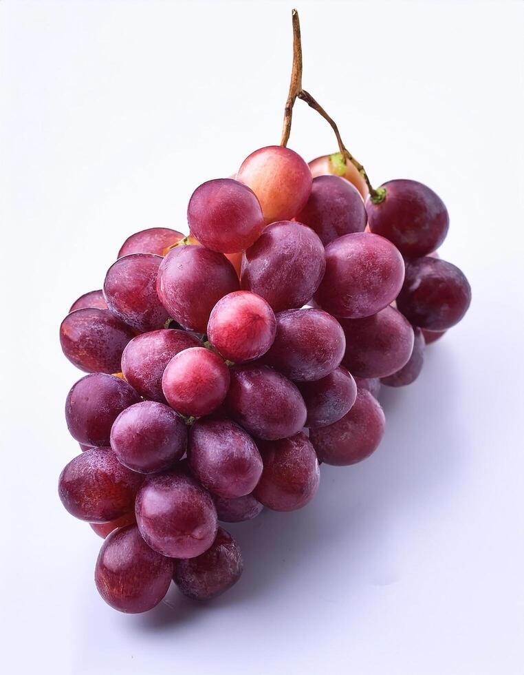 A bunch of purple grapes with one separate grain, focus on the skin texture isolated on white background photo