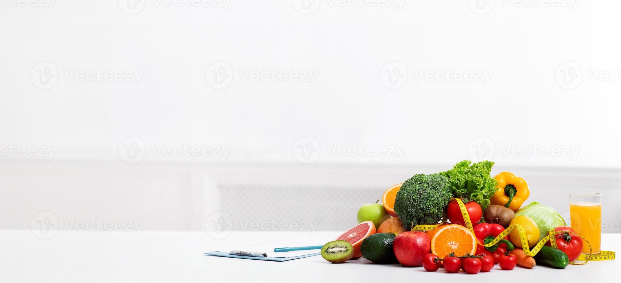 Dietologist empty workplace with fruits, vegetables, measuring tape and medical chart on table, copy space photo