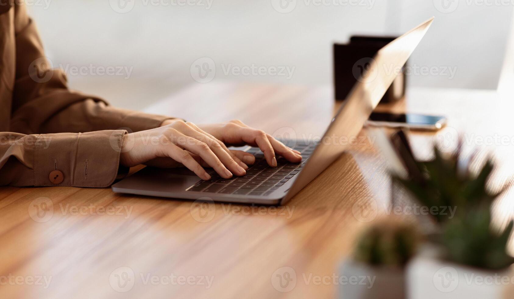 Home Office. Side view of young female manager using laptop, working remotely. Copy space photo