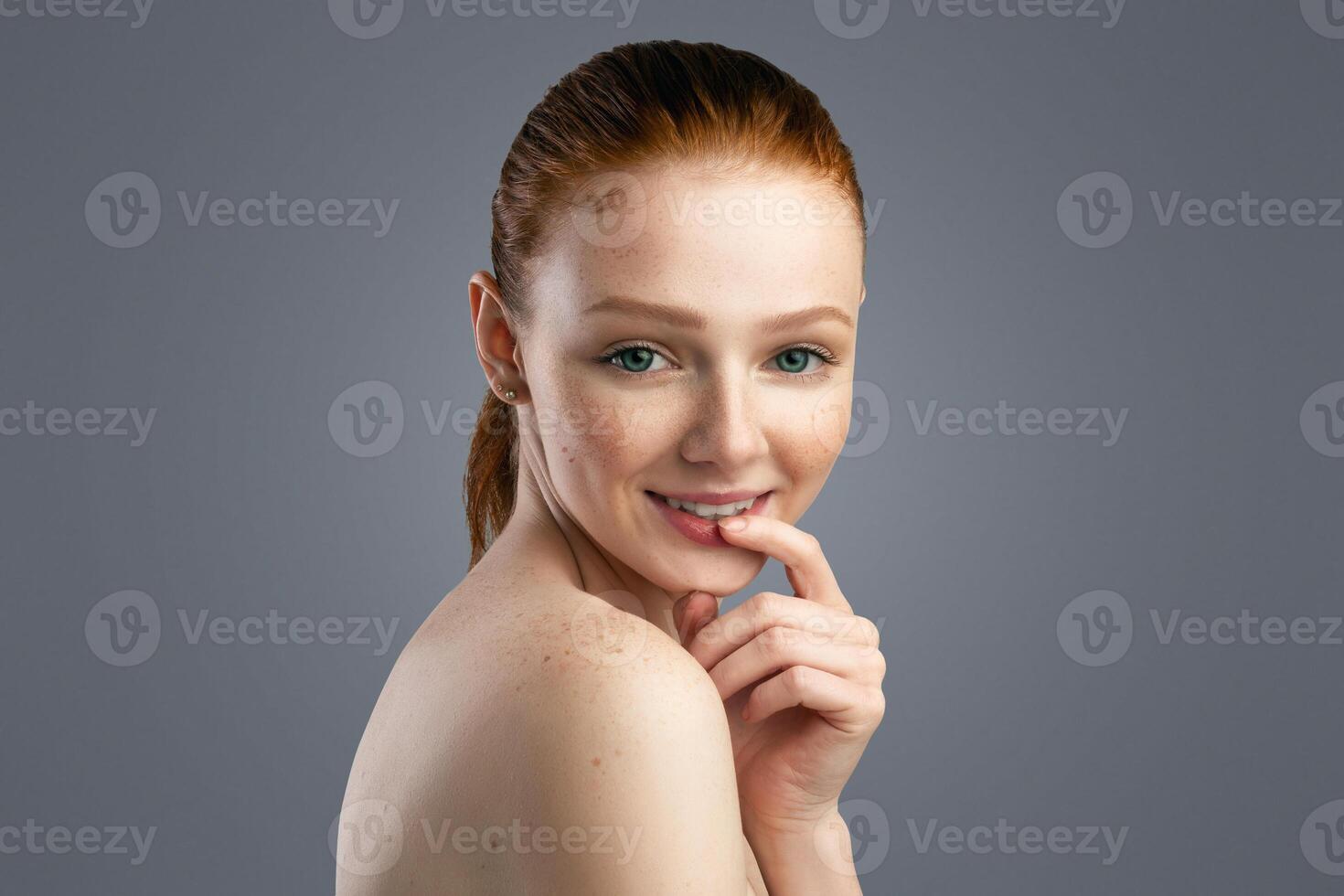 Facial Skincare Concept. Happy Red-Haired Young Lady Posing Touching Lips Smiling To Camera Over Gray Studio Background. Panorama With Copy Space For Text Advertisement. Female Beauty Portrait photo