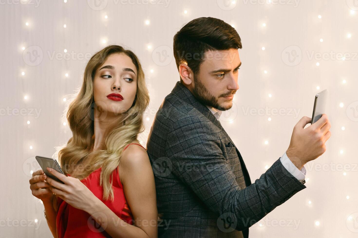 Mistrust Concept. Curious Woman Peeking Into Boyfriend's Smartphone Over Shoulder, Trying To Read His Messages After Their Quarrel In Restaurant photo