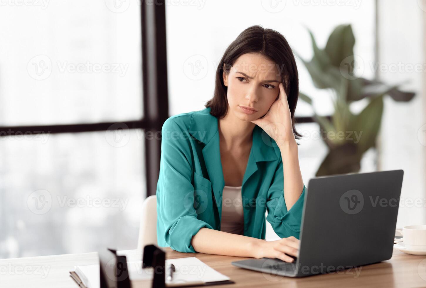 Lack Of Motivation. Portrait of stressed upset female student working on computer at home, looking away, copyspace photo