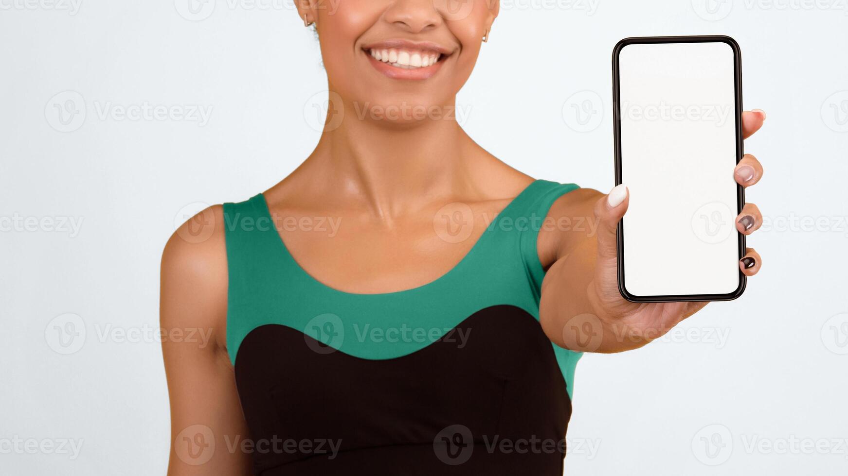 Workout App. Sporty Afro Woman Showing Smartphone With Empty Screen Over Yellow Studio Background. Panorama, Cropped, Mockup photo