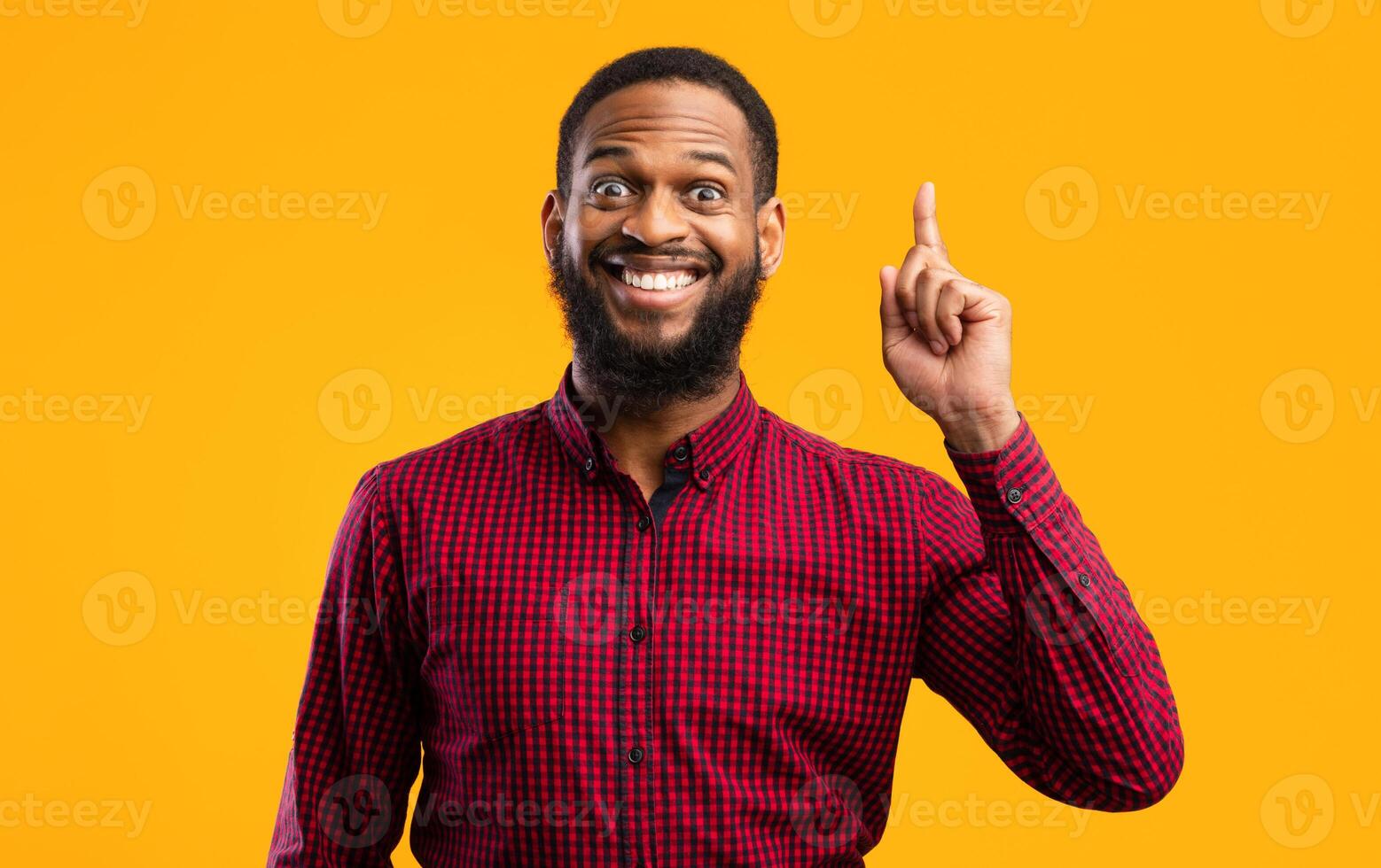 Great Idea Concept. Young Funny African American Man Pointing Finger Up. Excited Black Guy Got Solution To His Problem, Having Aha Moment, Isolated On Yellow Studio Background. Wow, Eureka photo