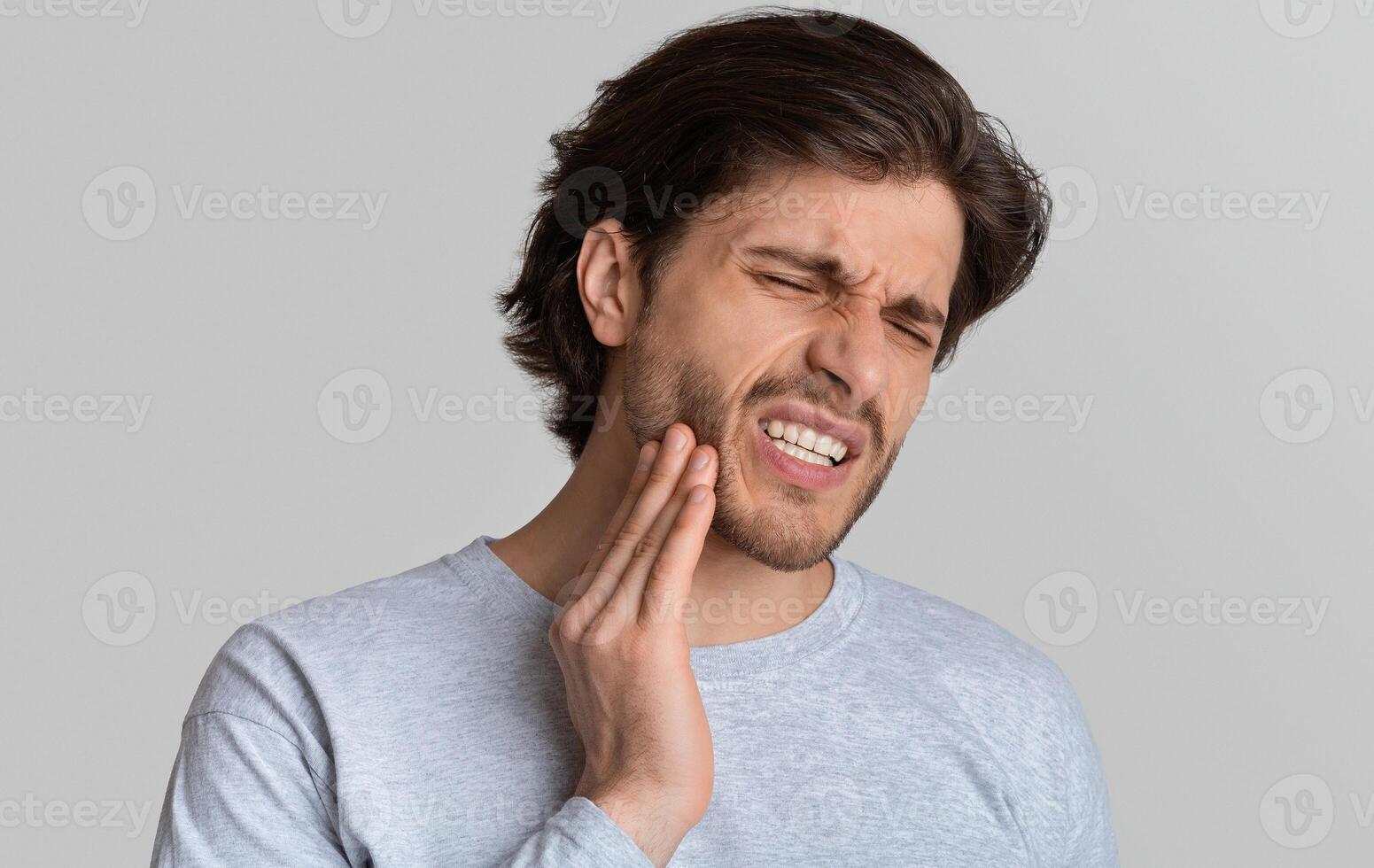 Dental problems concept. Man suffering from bad toothache, empty space photo