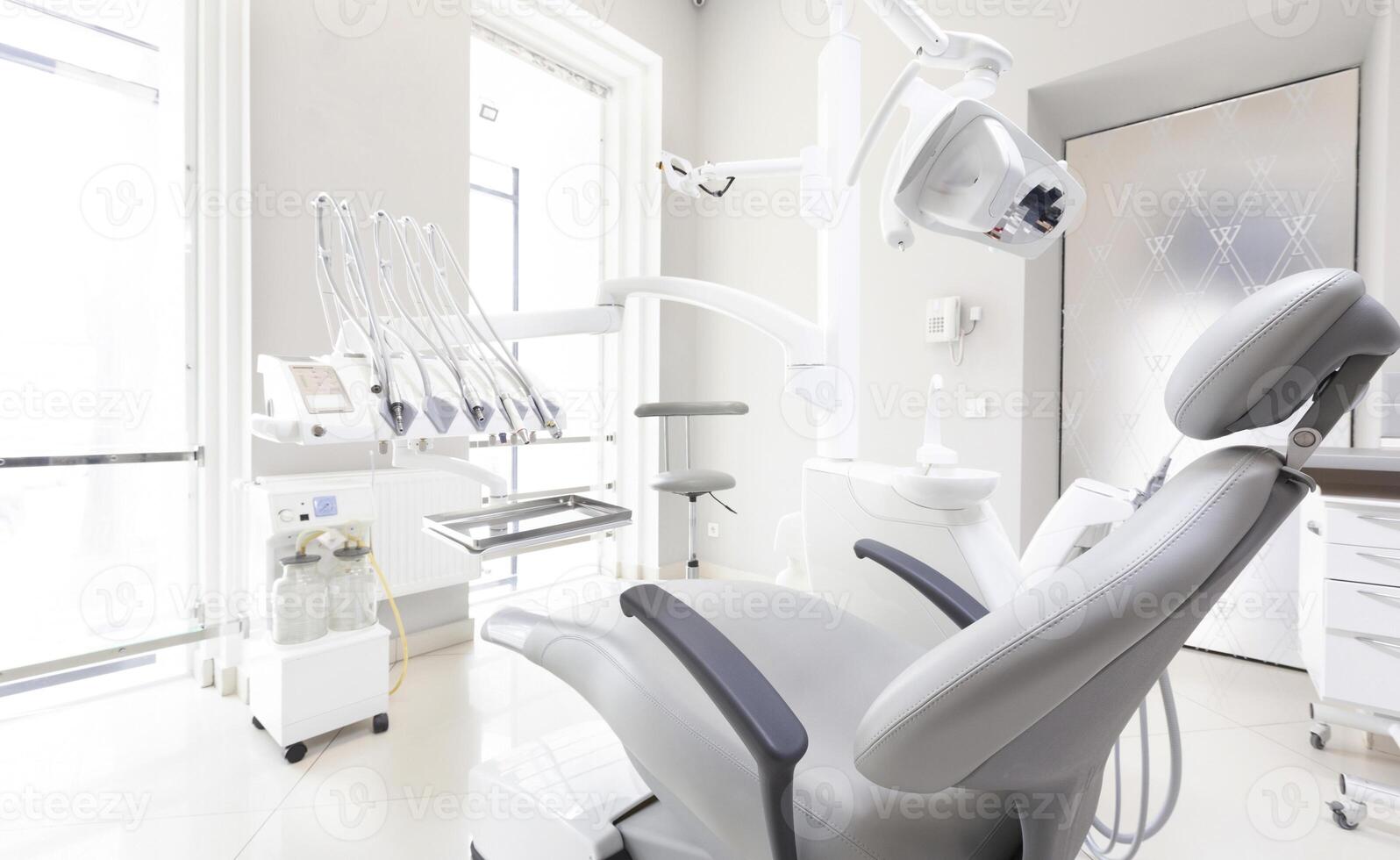 Dentist tools and professional dentistry chair in modern clinic, orthodontist room, copy space photo
