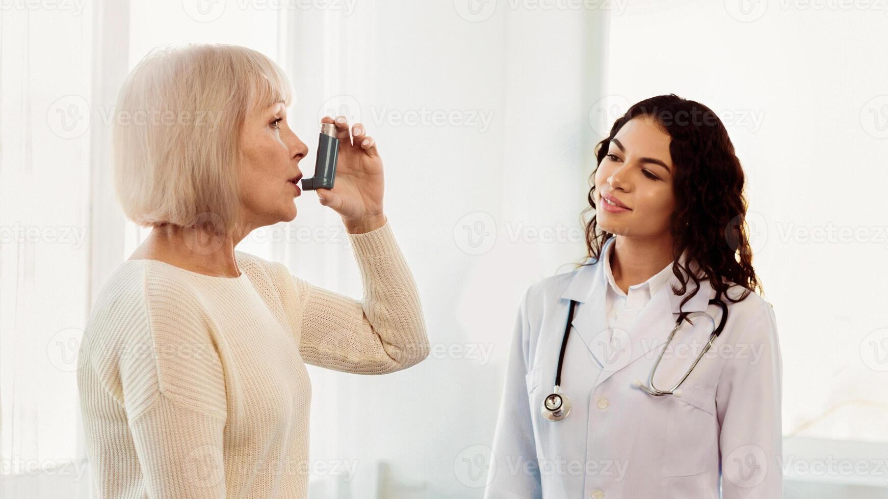 Medical Advice. Elderly woman using asthma inhaler, mexican doctor watching, free space, panorama photo