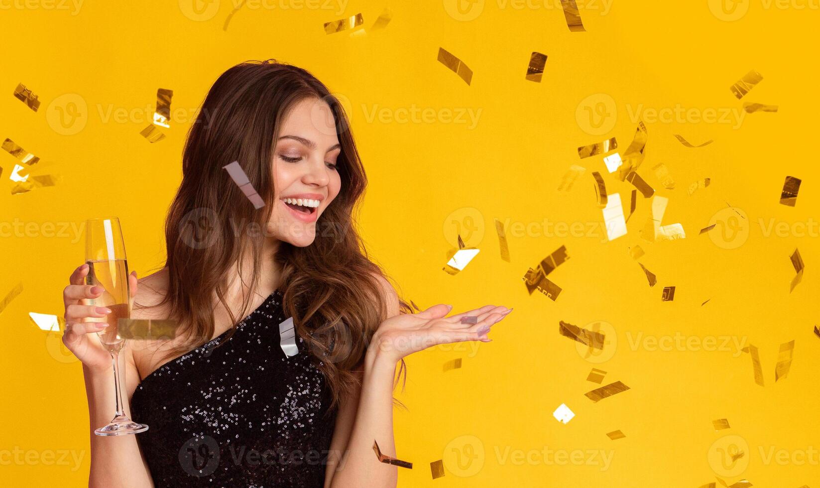 Celebration Fun. Happy Millennial Lady Enjoying Party With Champagne And Falling Confetti All Around, Colorful Background, Panorama photo