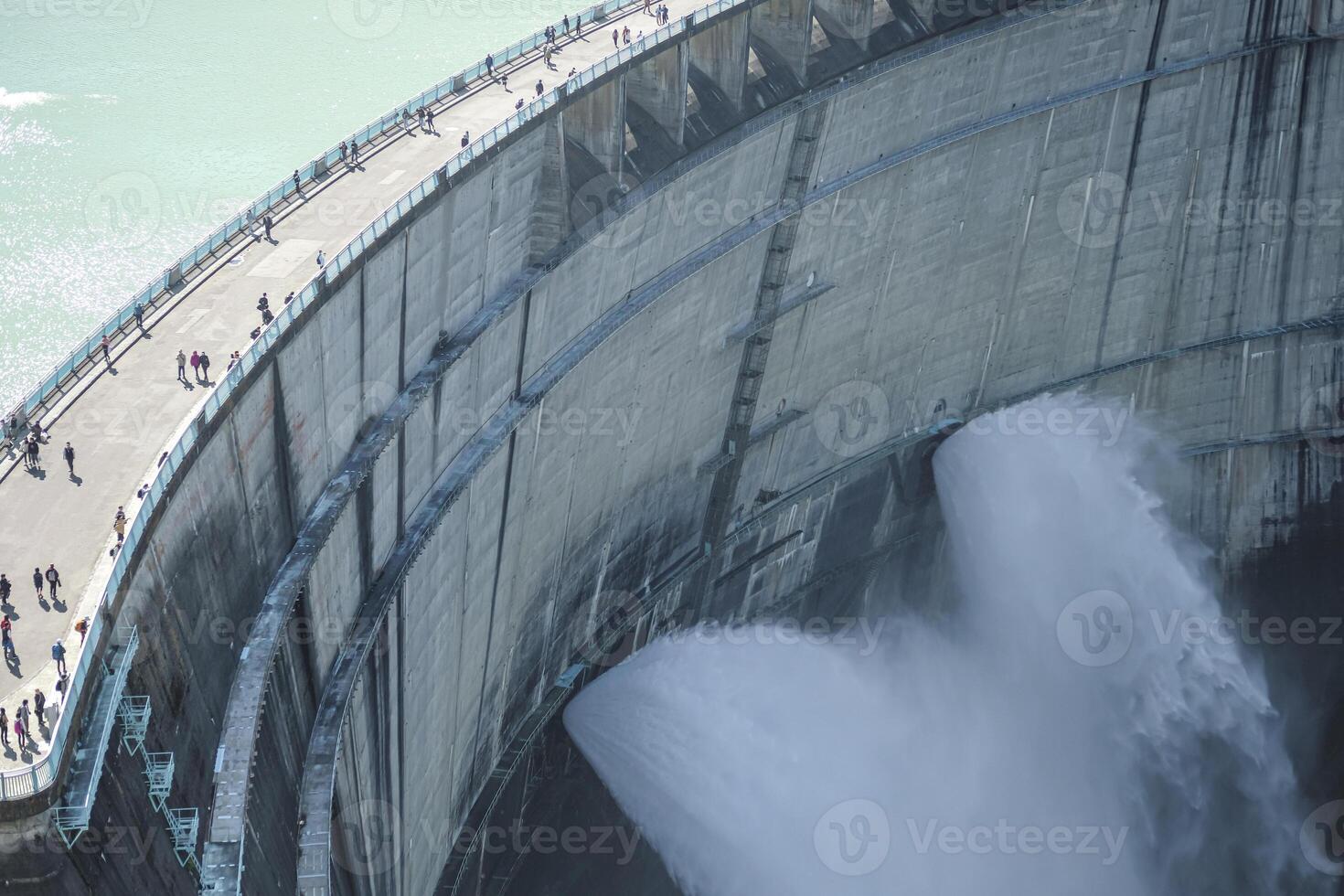 Kurobe Dam, Tateyama, Toyama, Chubu, Japan A large dam with water cascading down photo