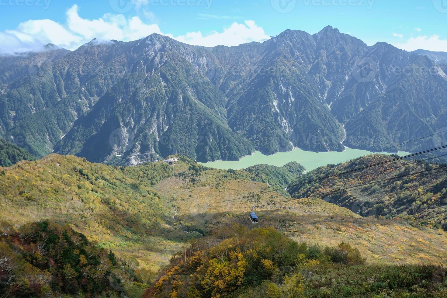 Kurobedaira Station, Tateyama, Toyama, Chubu, Japan, A breathtaking view of lush mountains and a serene lake photo