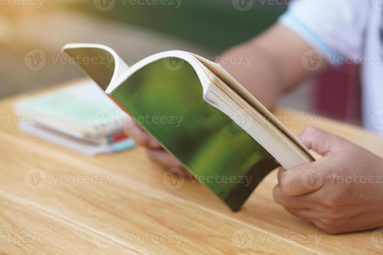 Close up man is reading book. Concept, self study, reading book for knowledge, pleasure or self development to apply knowledge in daily life living. Read for preparing exam. photo