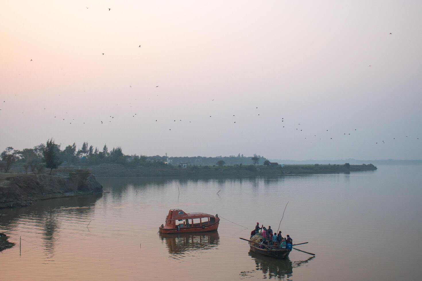 Peoples are crossing over the river by boat photo
