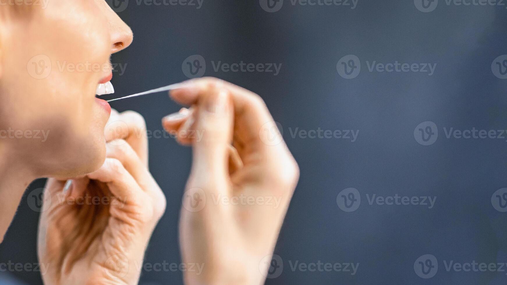 Toothcare. Unrecognizable Woman Flossing And Cleaning Teeth Preventing Cavity Doing Morning Routine In Bathroom. Empty Space photo