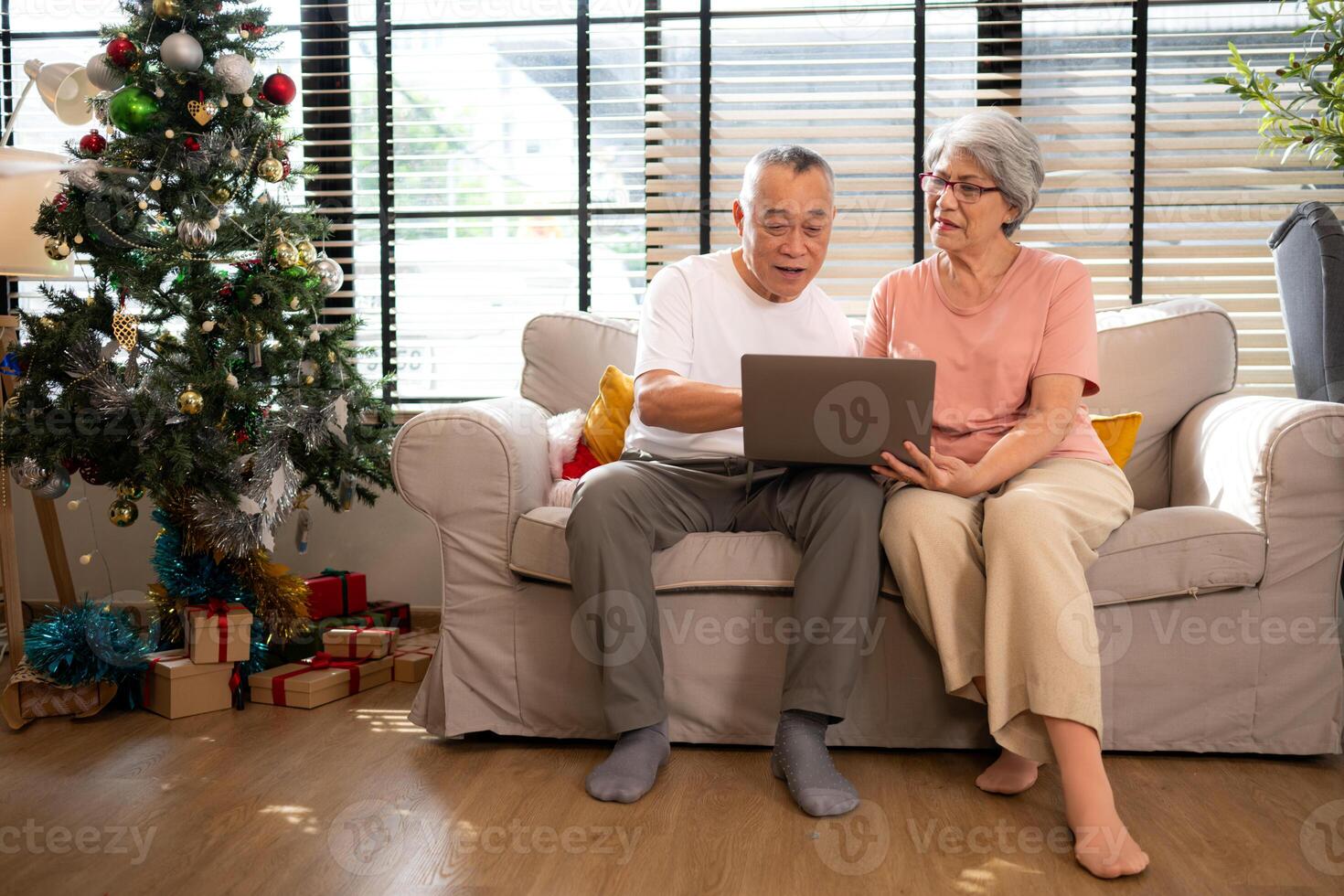 Grandfather and grandmother are reviewing the expenses and the food menu to host their children and grandchildren during the Christmas holiday at home photo
