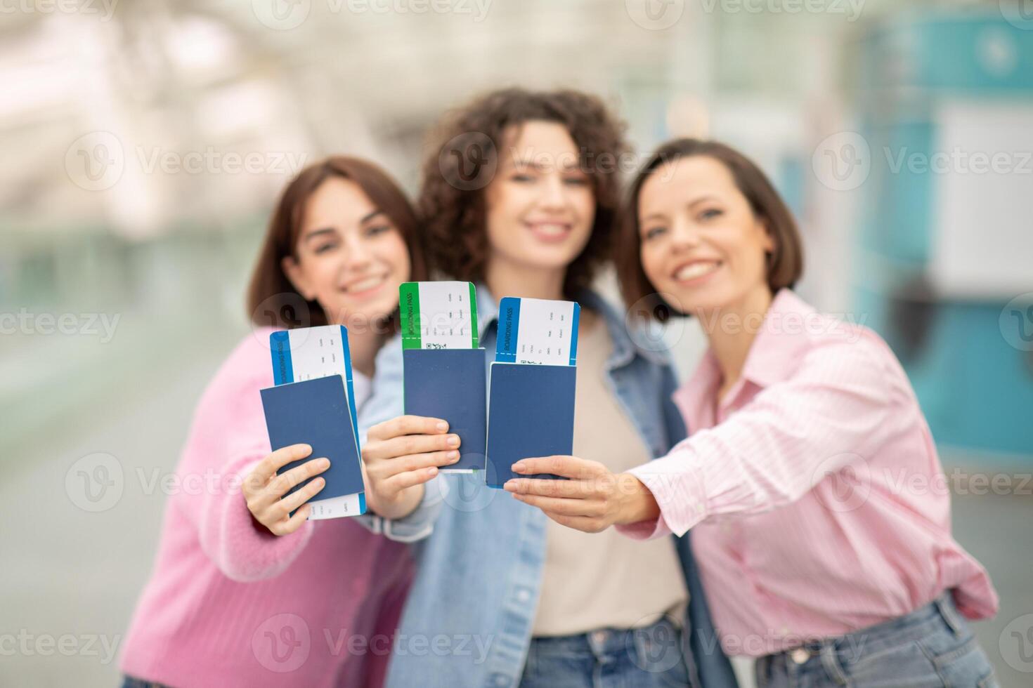 Three friends happily showcase their passports and travel tickets at the airport, excited for their upcoming adventure together. The atmosphere is filled with anticipation and joy. photo