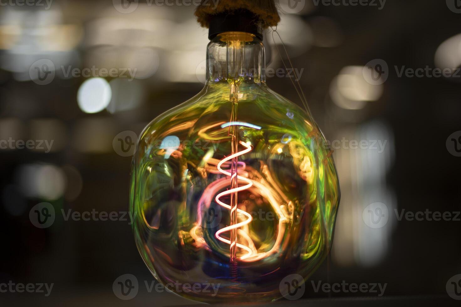 Colored lamp. Beautiful glass. Incandescent lamp made of bright glass. photo
