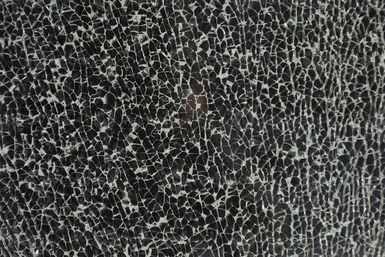 Cracked glass. Texture of small cracks. Broken window. photo