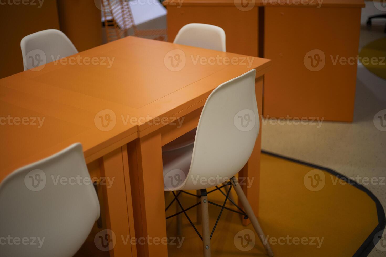Orange table. Chairs at the table. Empty places. photo