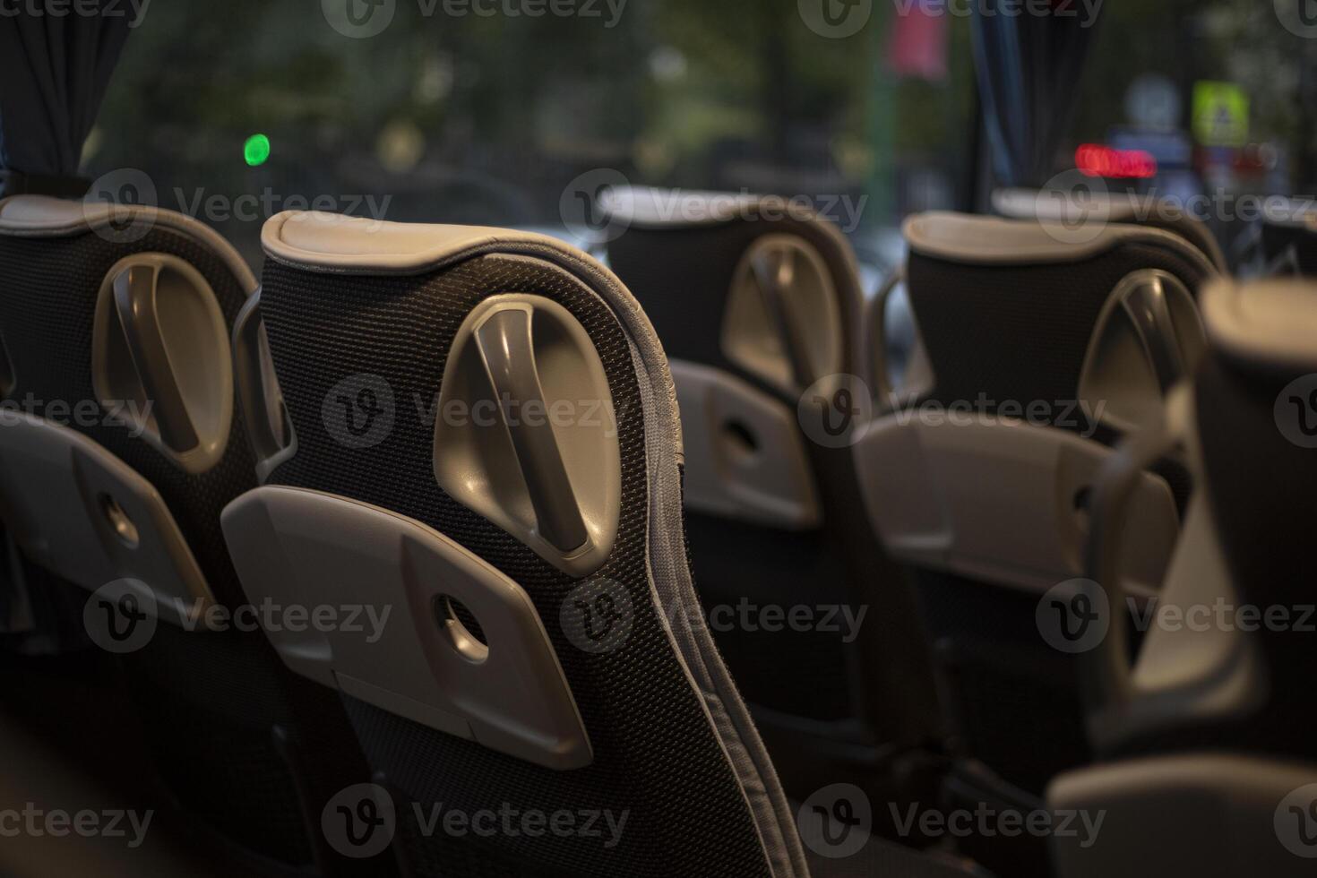 The interior of the bus. Seats inside the transport. Empty seats in the bus cabin. photo