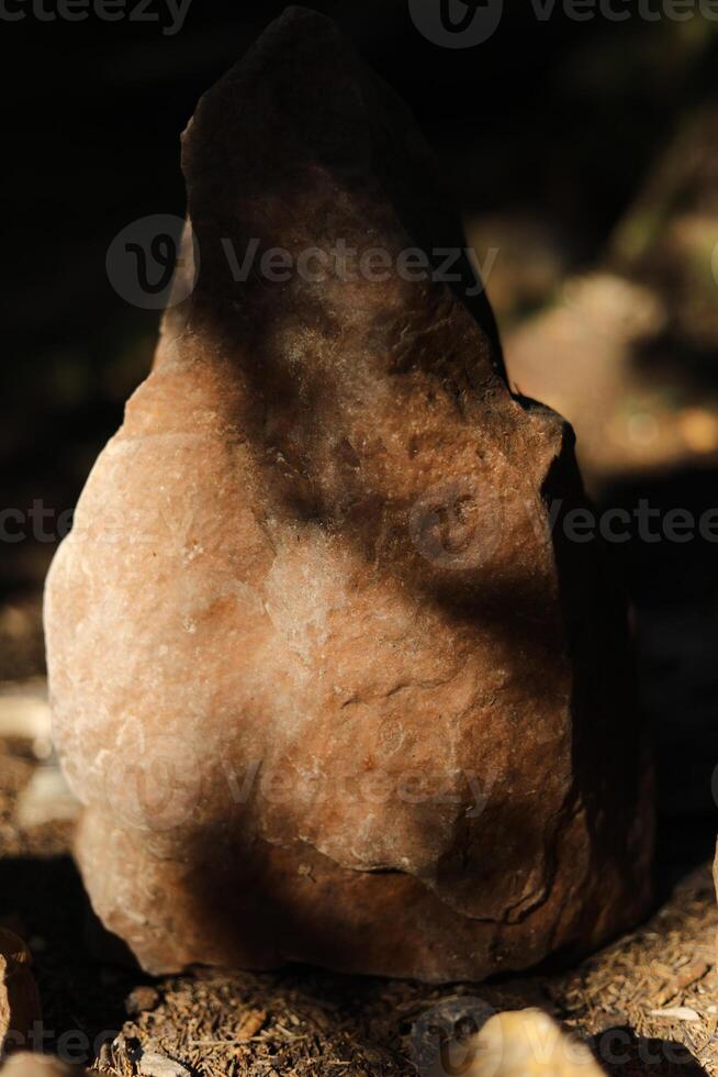 Stones in the sunlight. Ancient rocks standing in a forest. Sedimentary rocks. photo