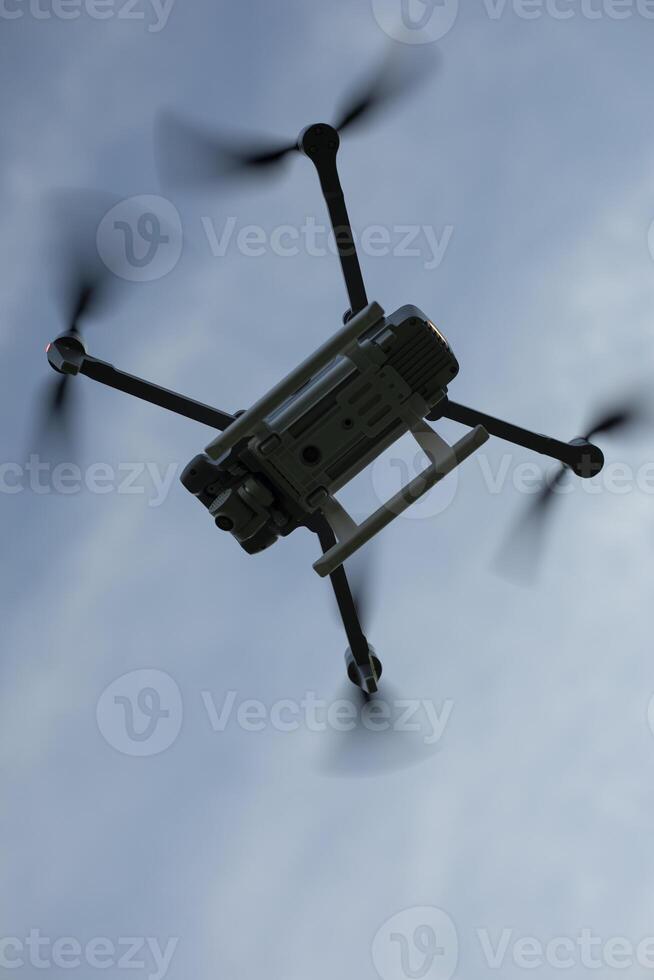 Drone in sky. Quadcopter flies through air. Small aircraft. Flight Technology. photo