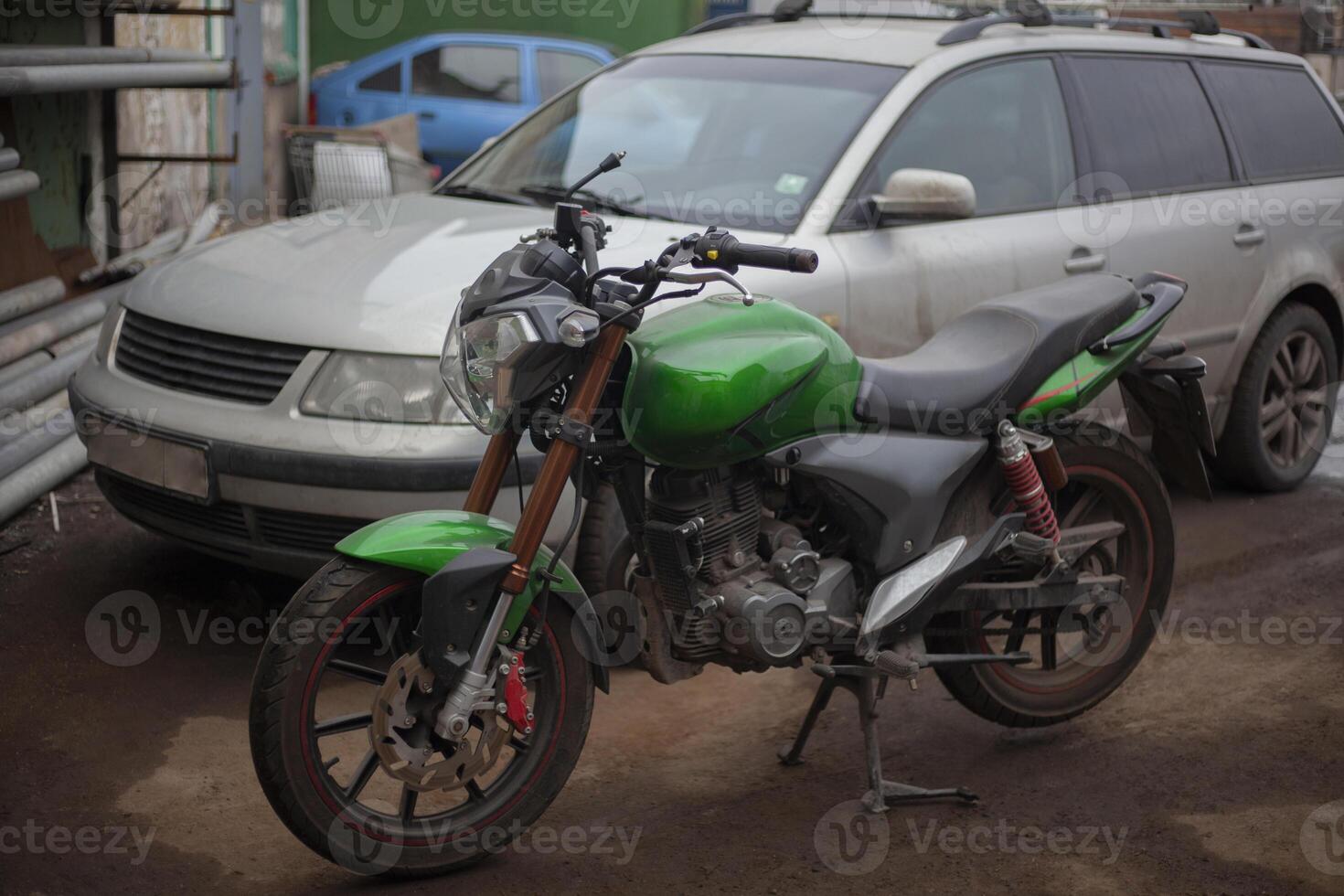 Motorcycle in the park. Parking transport. Green Bike. photo