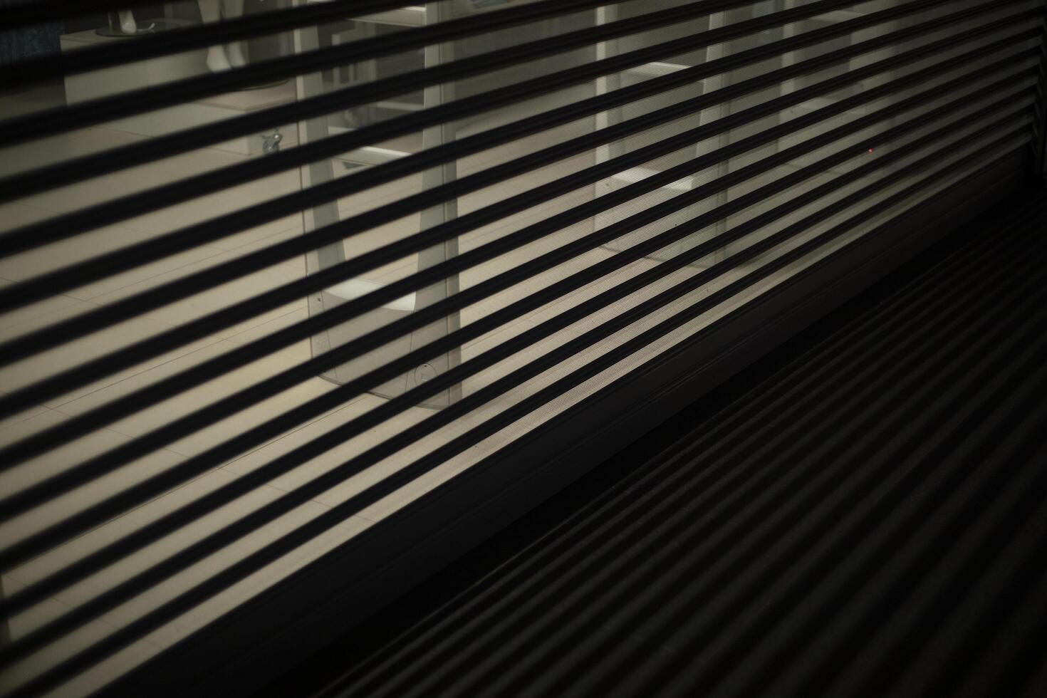 Closed blinds to the store. Closed curtain in a boutique. Horizontal lines on glass. photo
