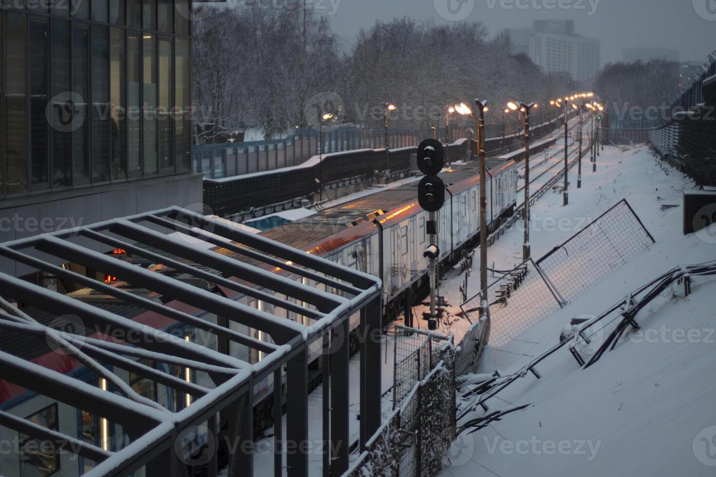 Railway in winter. Exclusion zone on the railway. Snow-covered landscape in an urban environment. photo
