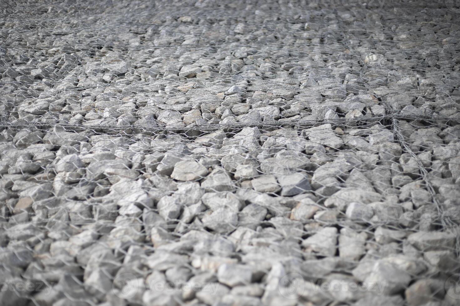Texture of stones. Stones under the net. Drainage system. photo