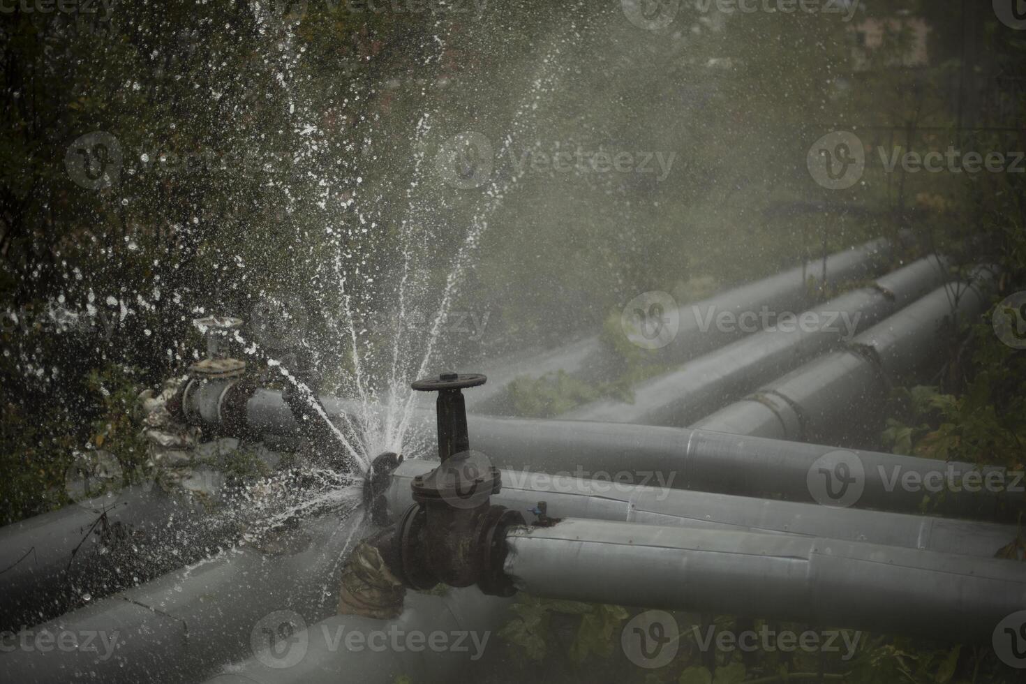 Burst pipe. Water pouring. Pipeline accident. It's dangerous situation. photo