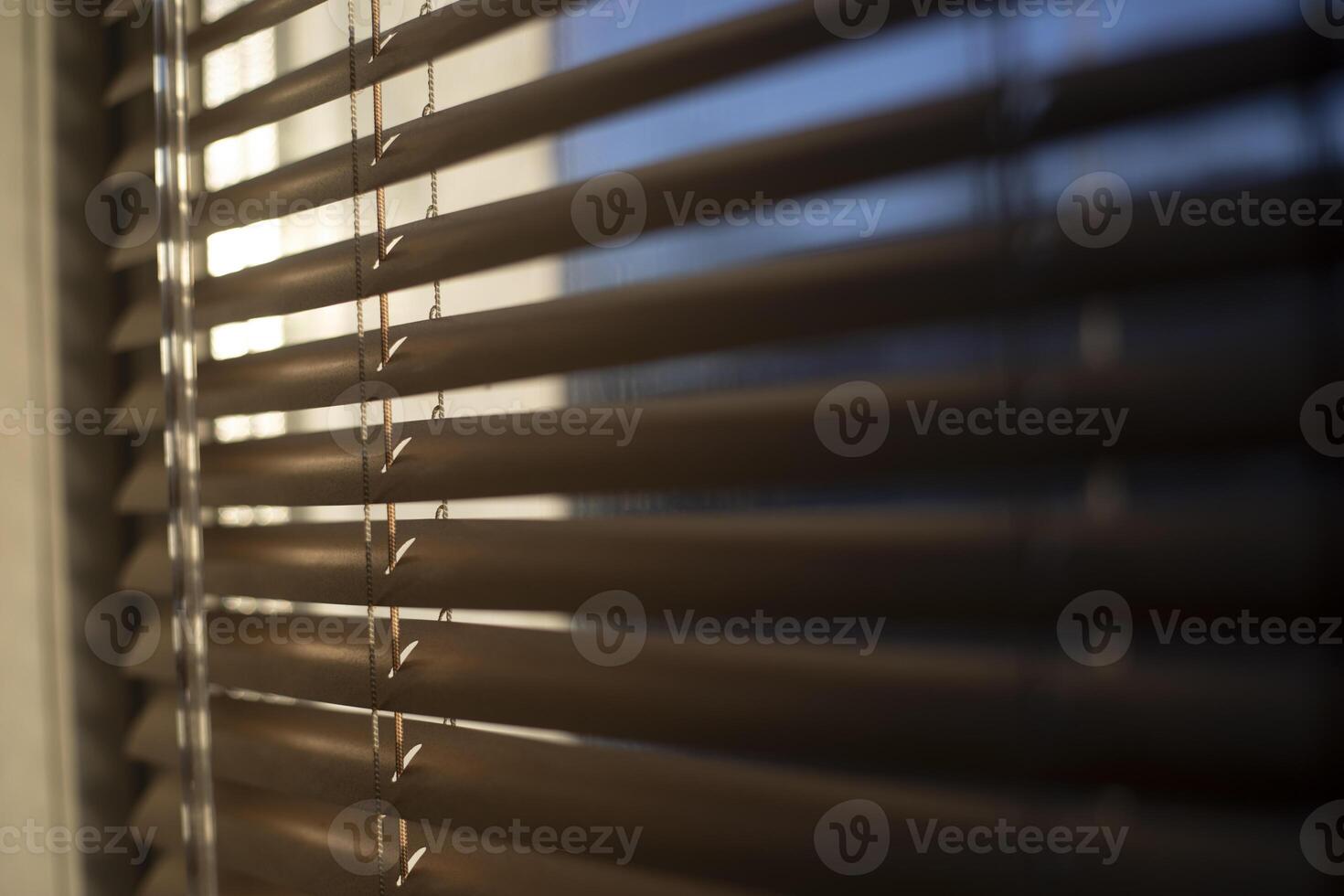 Blinds on the window. Interior details. Light through glass. photo