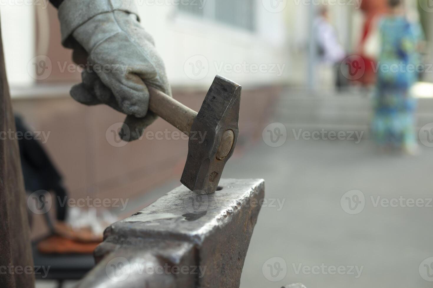 Blacksmith hits anvil. Hammer and anvil. Metal Processing Details. photo