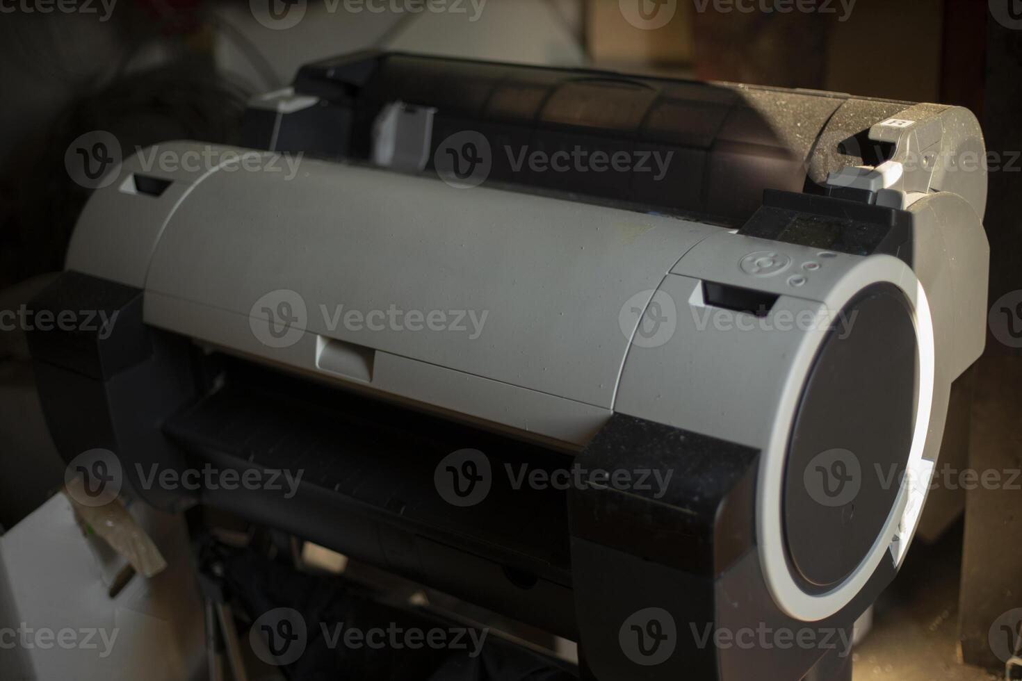 Large printer for printing on paper. Printing equipment in the garage. Inkjet printer in the room. photo