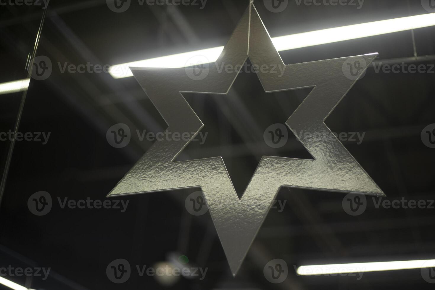 New Year's window decoration. A large snowflake hangs indoors. photo