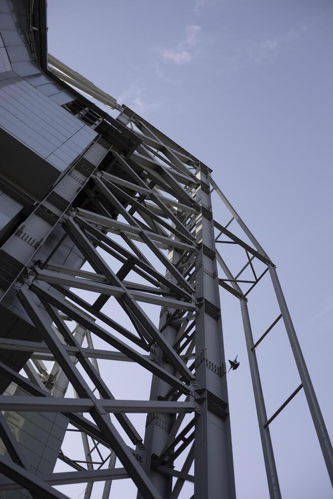 Steel structures in the building. Large building outside. Steel beams on the roof. photo