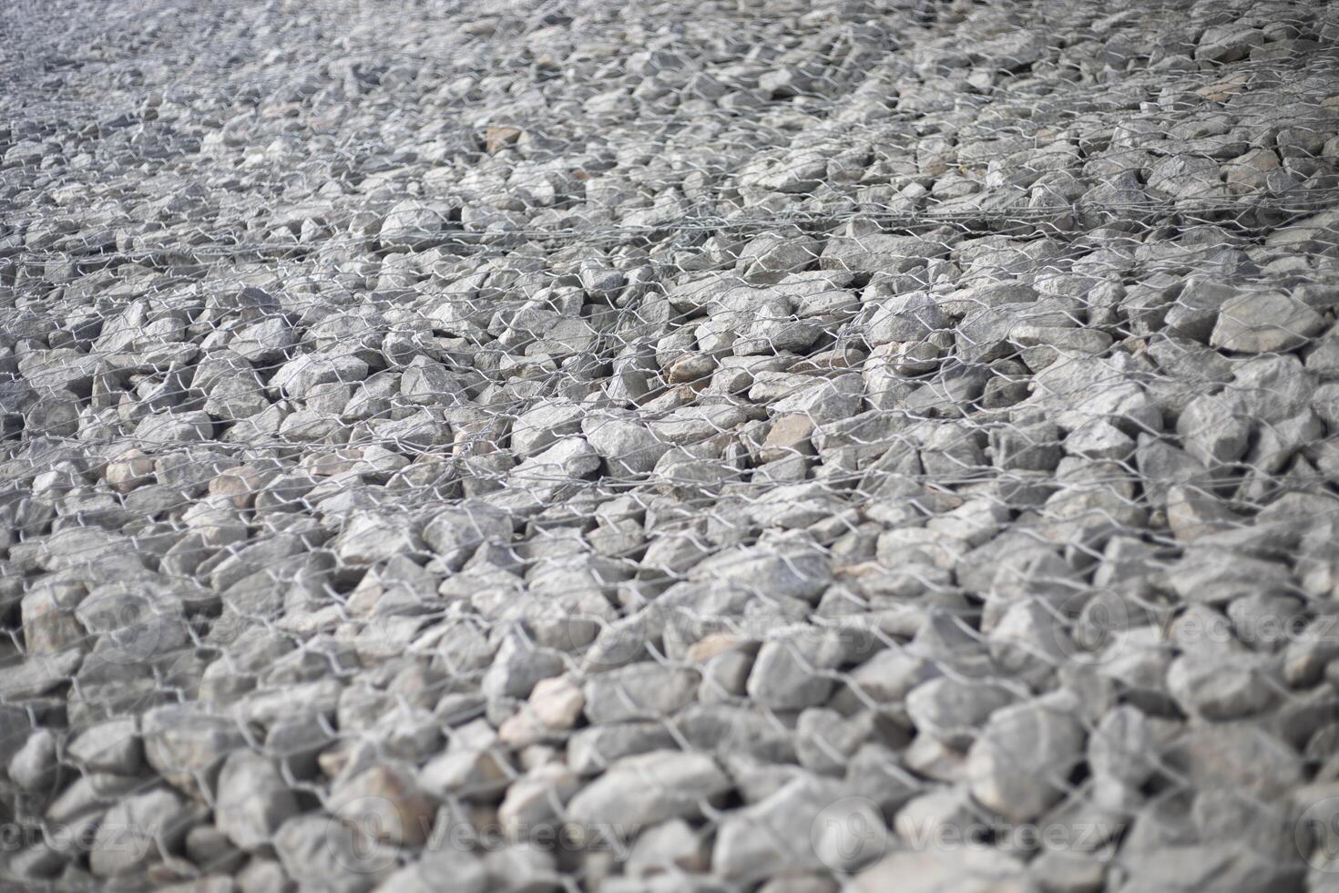 Texture of stones. Stones under the net. Drainage system. photo