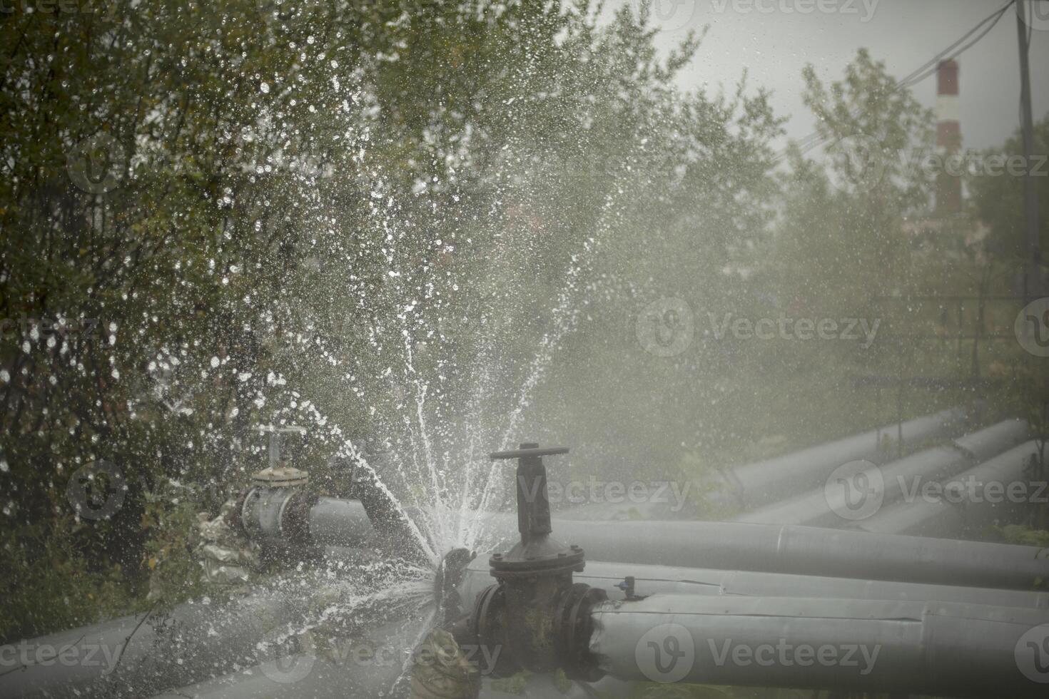 Pipe accident. Water breakthrough. Hot water flow. Damage to pipeline. photo