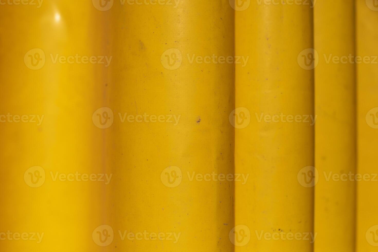 Yellow rubber material. Yellow curtain from moisture. Folds on material. photo