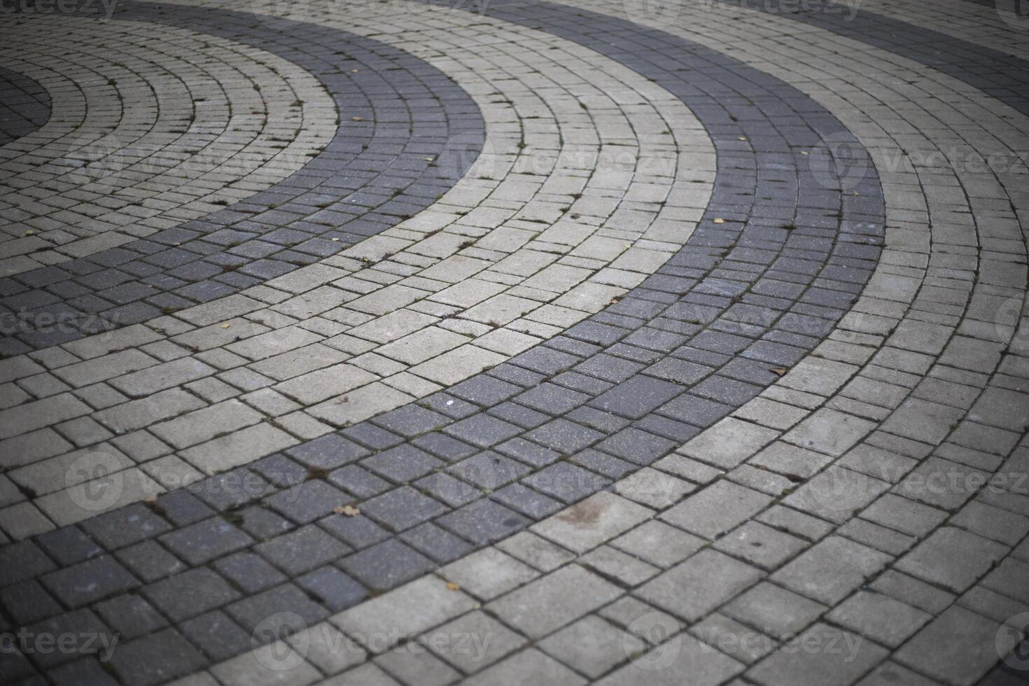 Tiles on the square. The paving stones lie in a circle. Area details. photo
