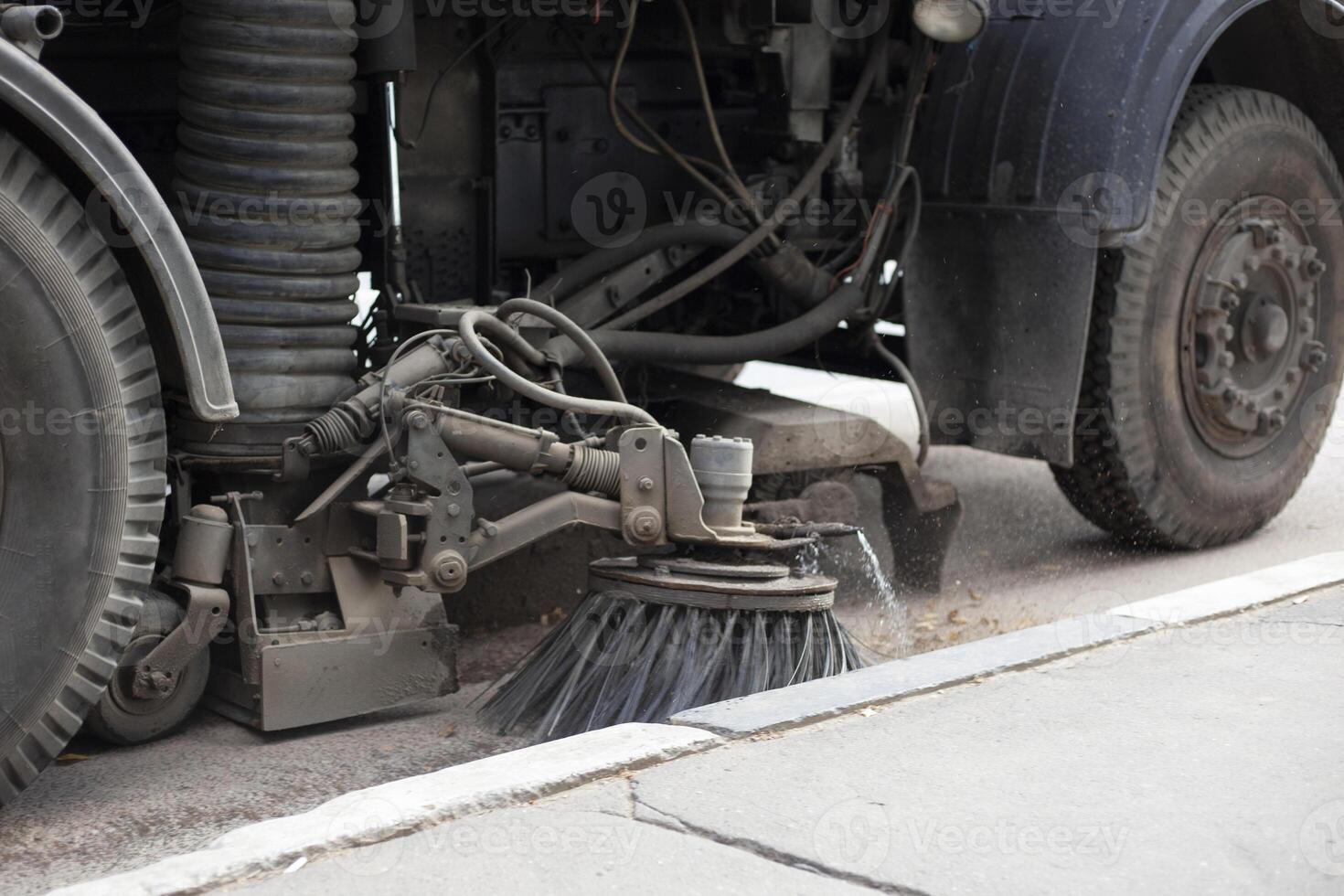 Harvesting machine on track. Heavy equipment for cleaning city from dirt. Utilities. photo