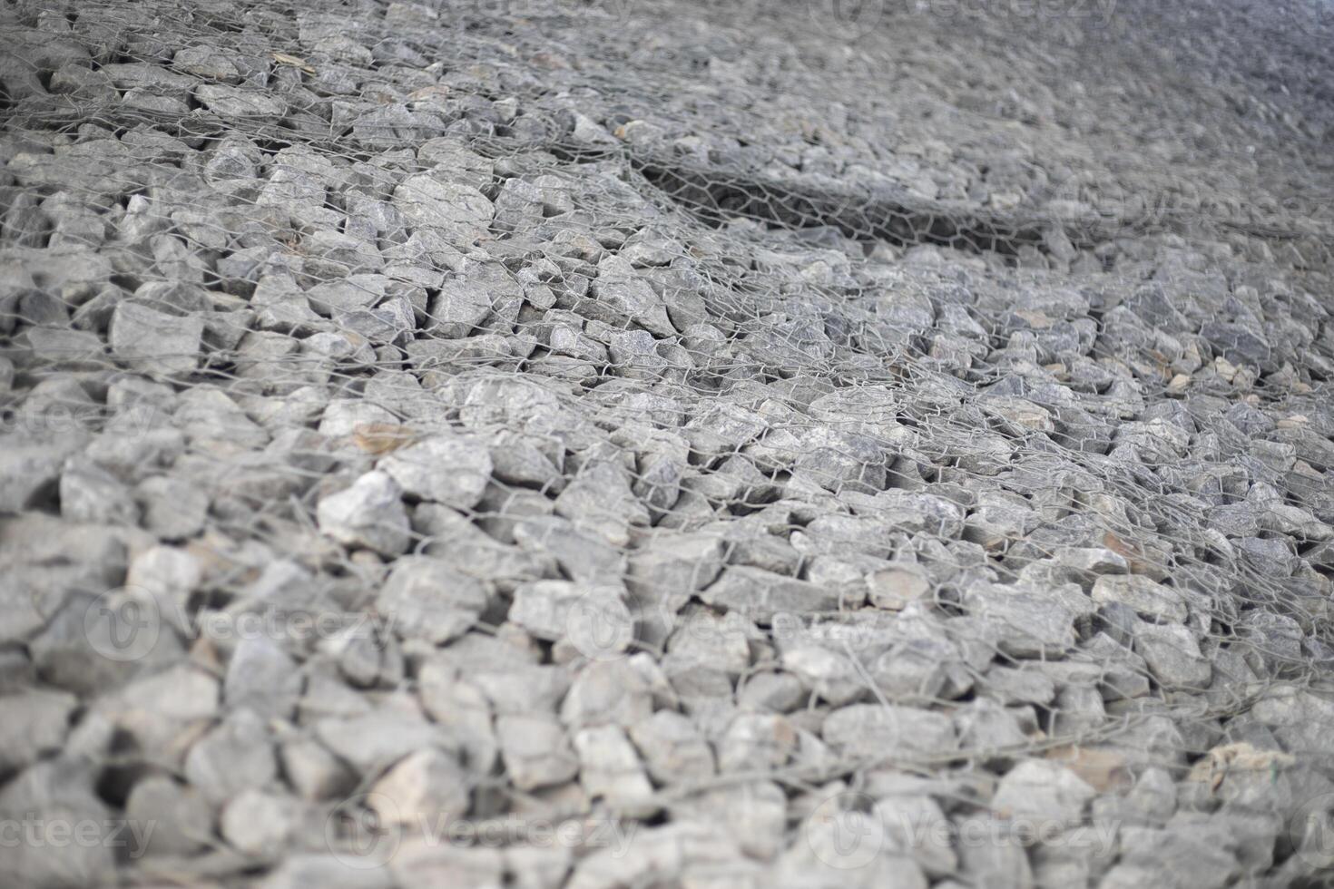 Texture of stones. Stones under the net. Drainage system. photo